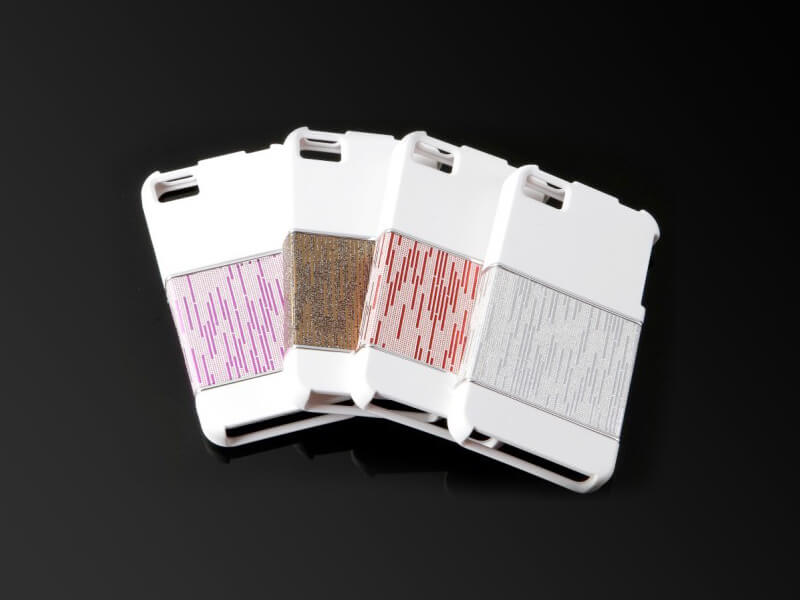 黑色表面上有四種不同顏色的 iPhone 手機殼。